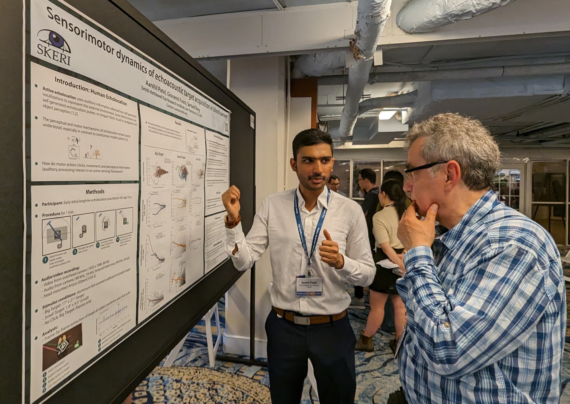 Arshil Patel presenting his poster to a VSS attendee
