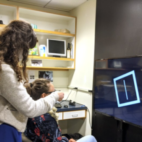 staff member performing an eye exam/study