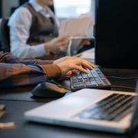 hands tying on a computer keyboard