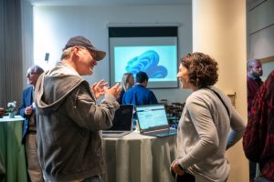 two FVA conference attendees engages in discussion